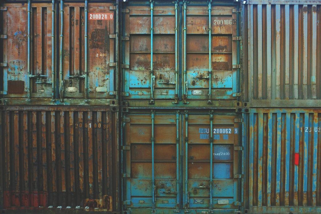 a mirror image of a blue gate reflected in water.